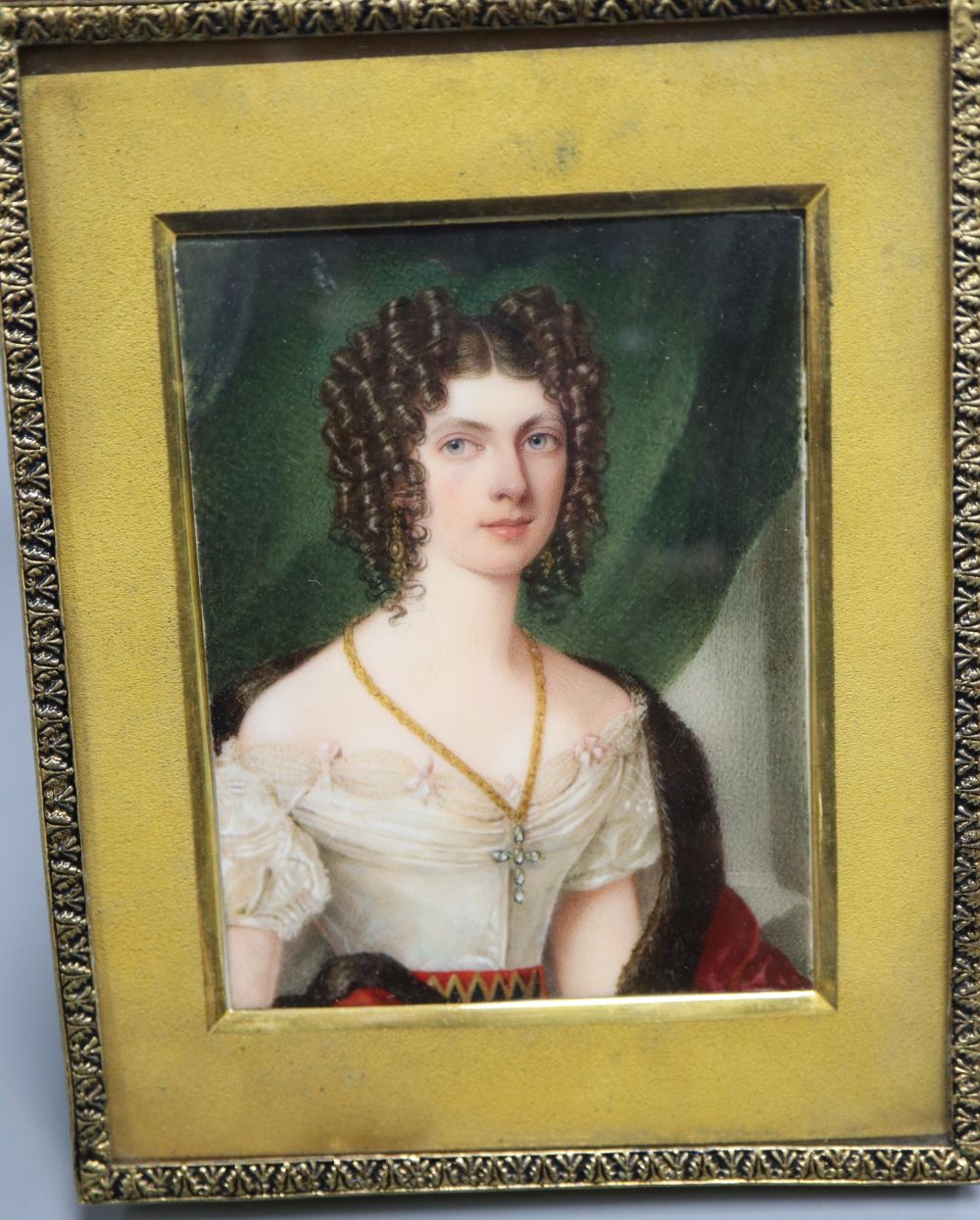 An early 19th century portrait miniature on ivory of a lady, half length, 8 x 6cm, later framed